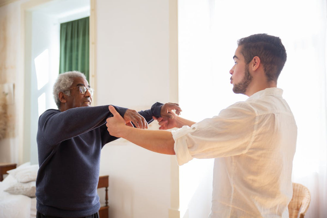 Caregiver holding the hand of an elderly person