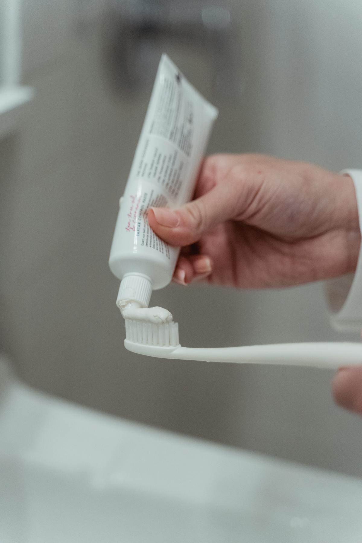 Applying toothpaste to a toothbrush