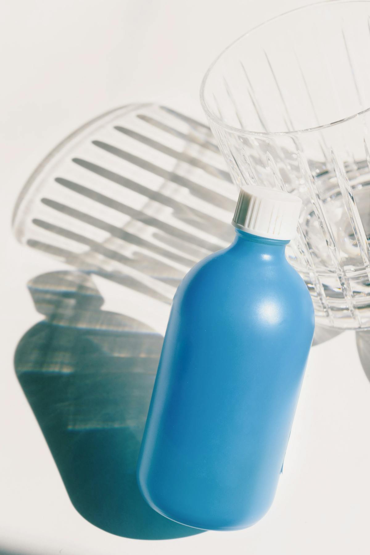 Bottle of mouthwash with a glass